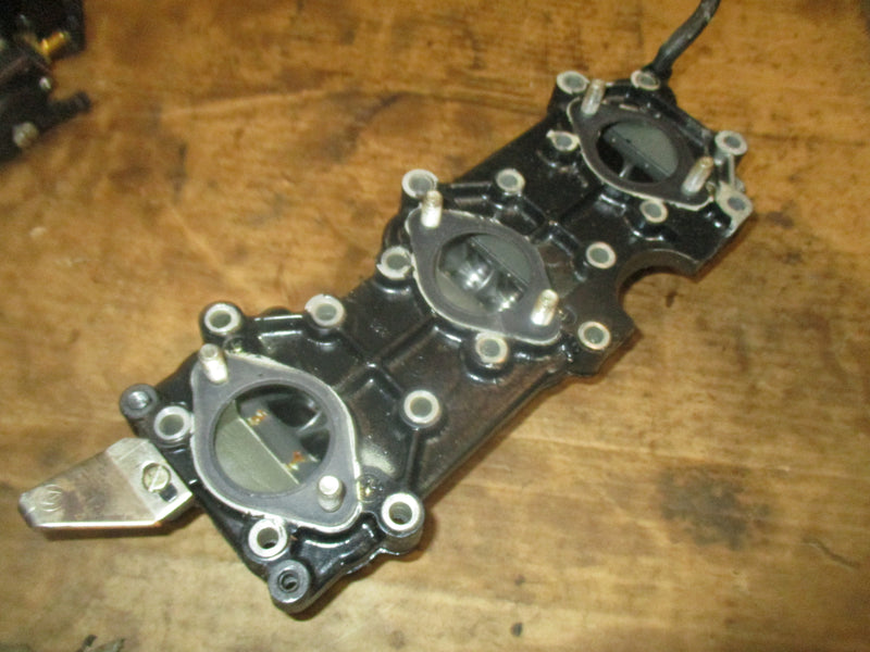 Evinrude VRO 70hp outboard intake manifold w/ reeds (389395)